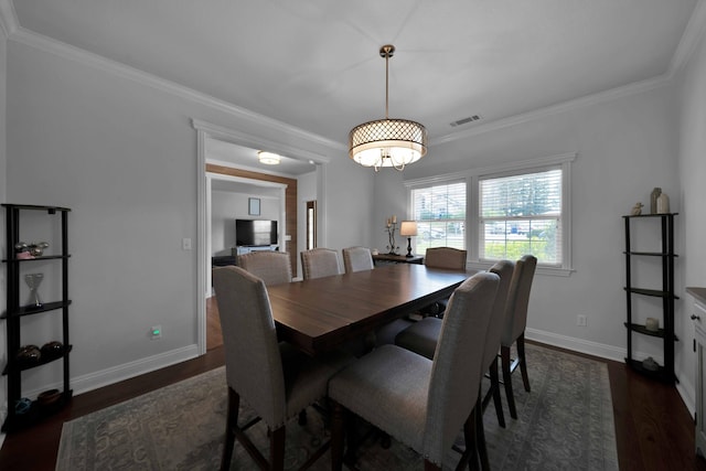 dining space featuring dark wood-type flooring, baseboards, and ornamental molding