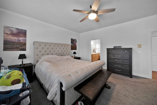 carpeted bedroom with ceiling fan, baseboards, ensuite bath, and ornamental molding