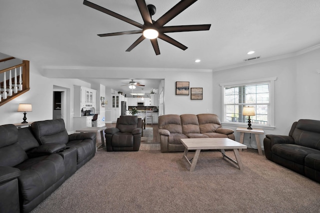 living area with visible vents, crown molding, carpet, stairway, and recessed lighting