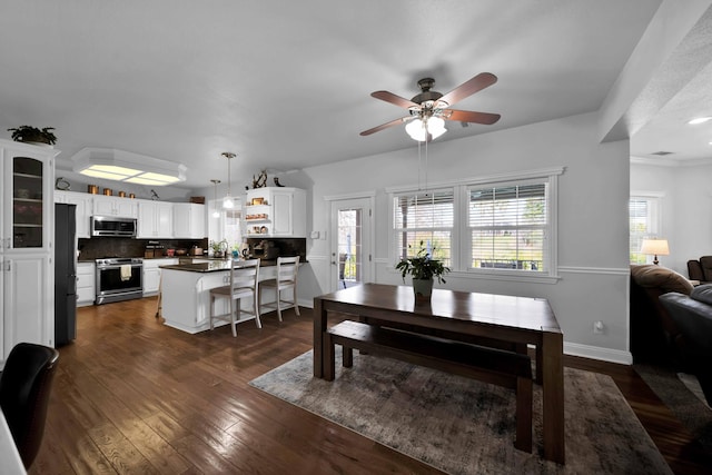 dining room with baseboards, dark wood-style flooring, and ceiling fan