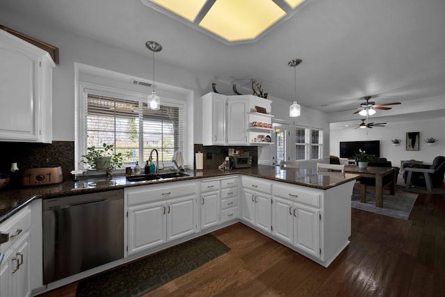 kitchen with dark wood-style flooring, dishwasher, a peninsula, and a sink