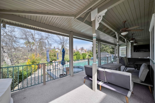 view of patio / terrace featuring an outdoor hangout area, a storage shed, an outbuilding, an outdoor pool, and a ceiling fan