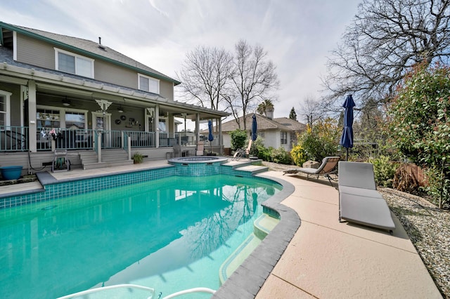 view of swimming pool featuring a patio, a pool with connected hot tub, and ceiling fan