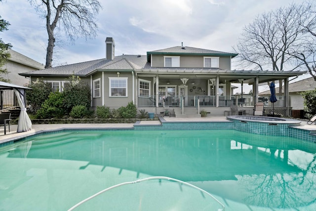 view of swimming pool with an in ground hot tub, a fenced in pool, and a patio area