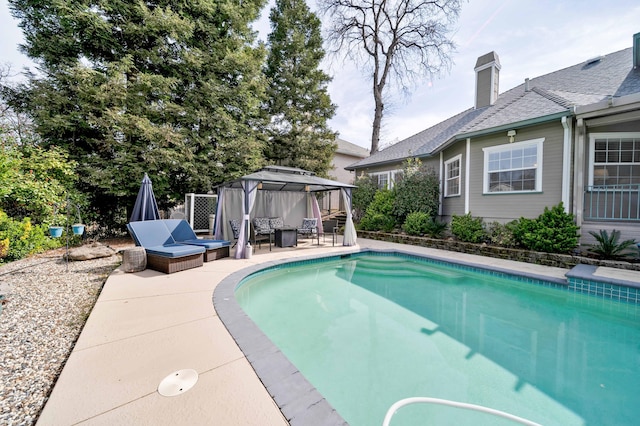 view of swimming pool featuring a gazebo, a fenced in pool, and a patio