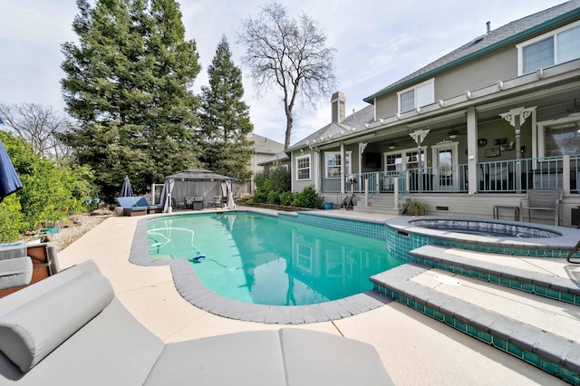 outdoor pool featuring a gazebo, an in ground hot tub, a patio area, and a ceiling fan