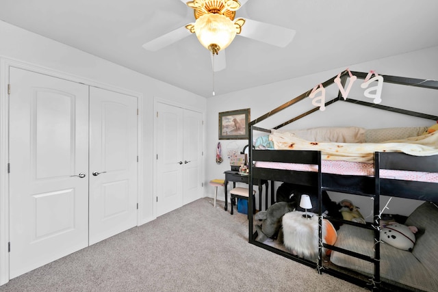 carpeted bedroom with multiple closets and ceiling fan