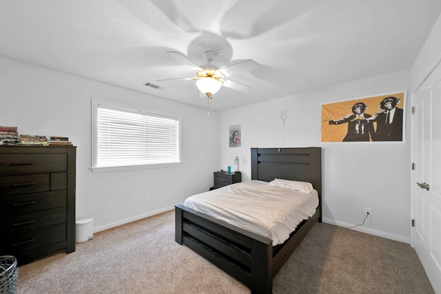 carpeted bedroom with a ceiling fan, baseboards, and visible vents