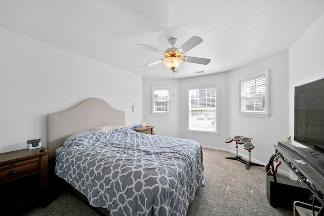 carpeted bedroom featuring visible vents, ceiling fan, and baseboards