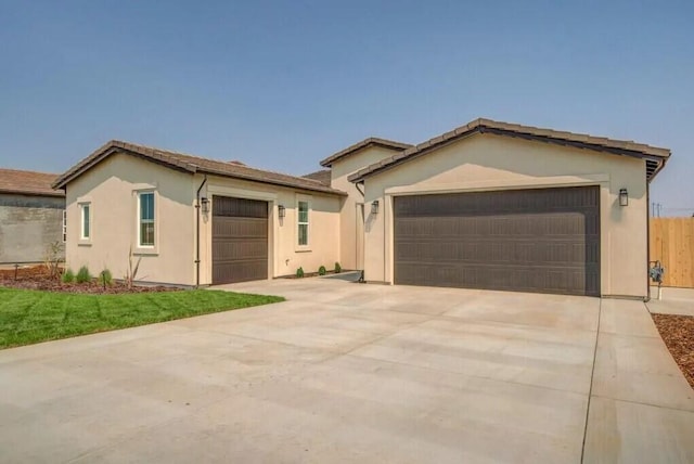 ranch-style house featuring concrete driveway, an attached garage, and stucco siding