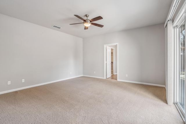 unfurnished room featuring ceiling fan, baseboards, visible vents, and light carpet