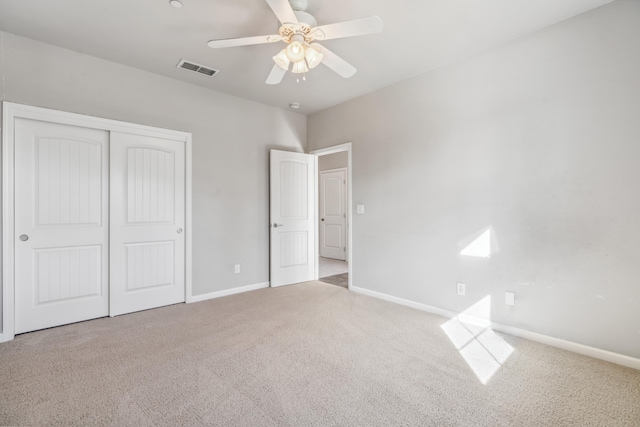 unfurnished bedroom with visible vents, baseboards, ceiling fan, carpet flooring, and a closet