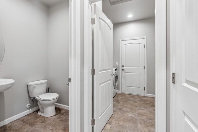 bathroom with baseboards and toilet