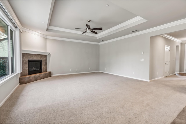 unfurnished living room featuring visible vents, a raised ceiling, and light carpet