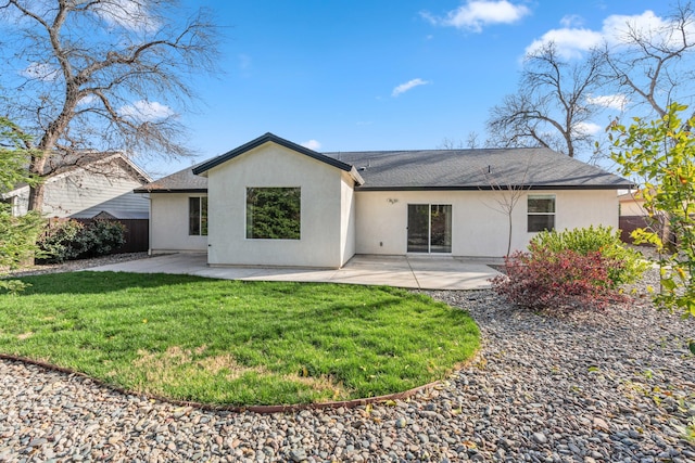 back of property featuring stucco siding, a patio, a yard, and fence