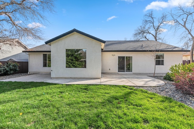 rear view of property with a patio, a yard, fence, and stucco siding