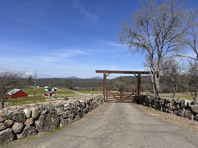 view of road with a gate and a mountain view