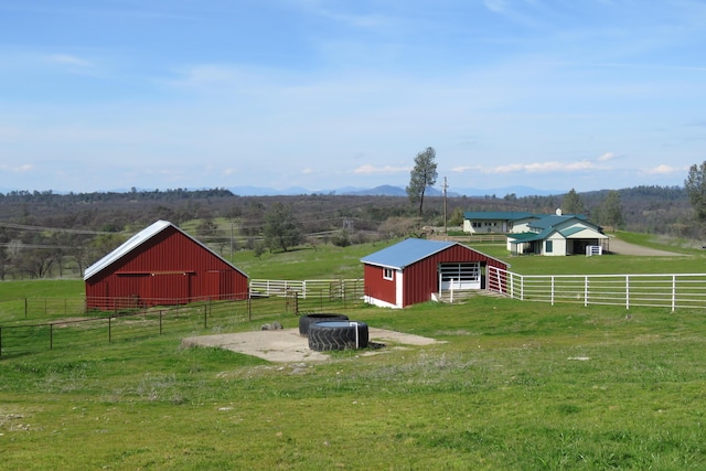 view of yard with an exterior structure, an outbuilding, and a rural view