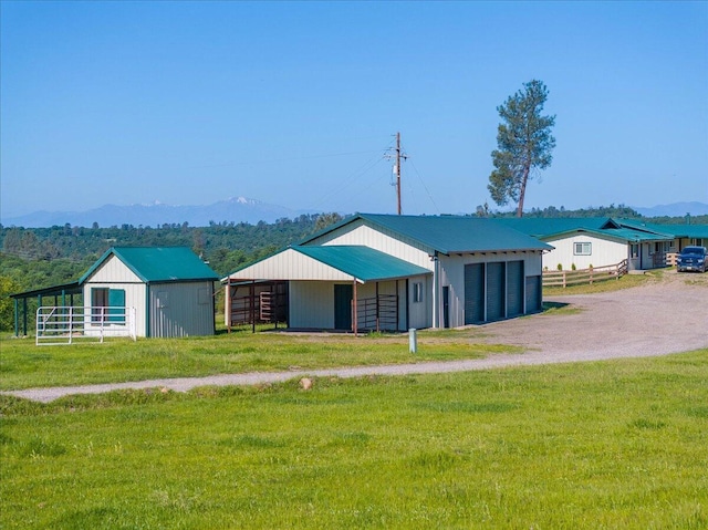 view of outbuilding with an outbuilding, a mountain view, and an exterior structure