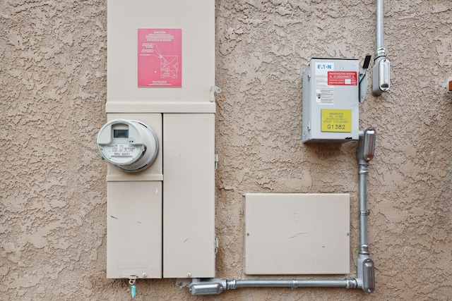 exterior details with stucco siding and electric meter