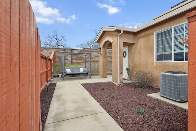 view of yard featuring a patio area, a fenced backyard, and central AC