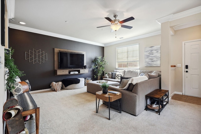 carpeted living area with tile patterned flooring, visible vents, baseboards, ceiling fan, and ornamental molding