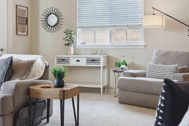 carpeted living room with baseboards