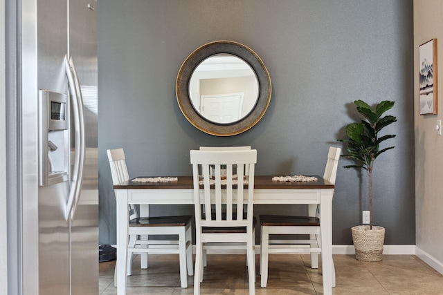 dining space featuring tile patterned flooring and baseboards