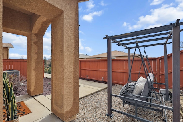 view of patio / terrace with cooling unit, a fenced backyard, and a pergola