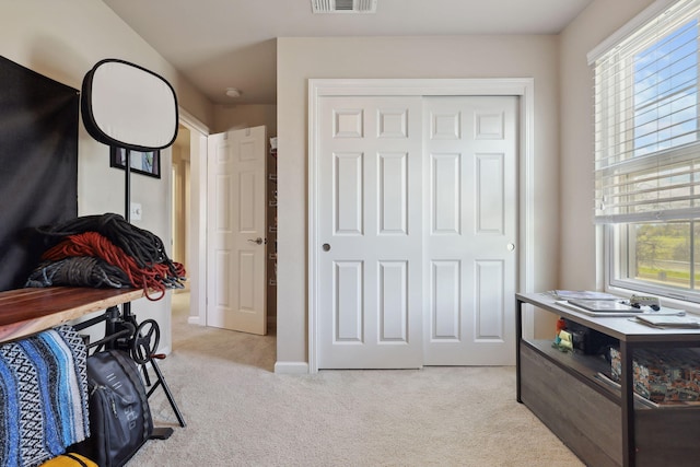 bedroom featuring a closet, visible vents, baseboards, and carpet