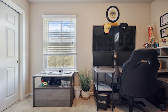 office area featuring plenty of natural light, baseboards, and carpet floors