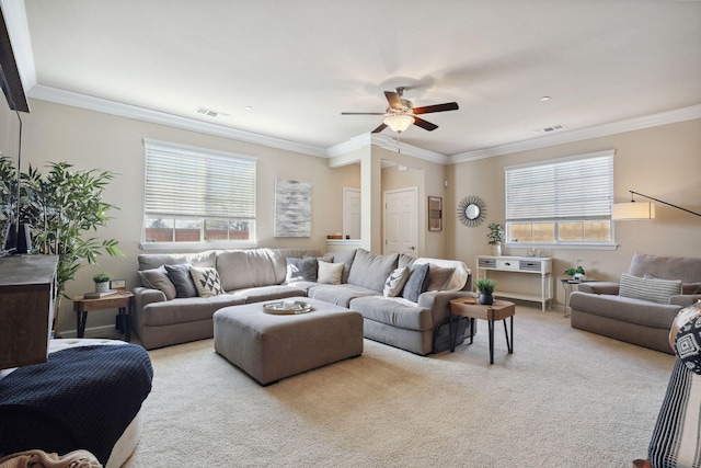 carpeted living room with visible vents, ornamental molding, and a ceiling fan