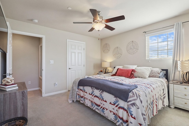 carpeted bedroom featuring ceiling fan and baseboards