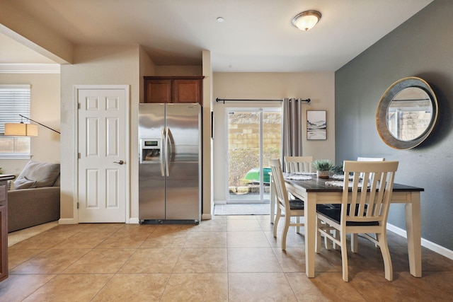 dining area with baseboards and light tile patterned flooring