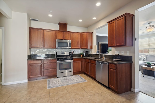 kitchen with dark countertops, visible vents, appliances with stainless steel finishes, and ceiling fan