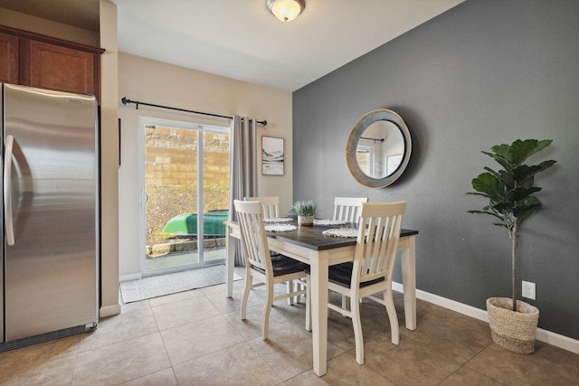 dining room with light tile patterned flooring and baseboards