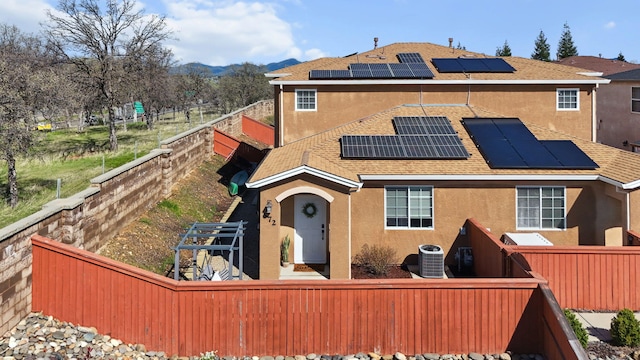 exterior space with stucco siding, cooling unit, and fence private yard