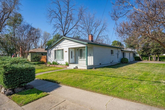 view of front of home with crawl space, an attached garage, a chimney, and a front lawn