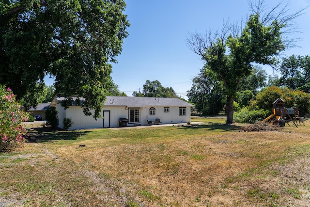7100 Aldo Way, Anderson, CA 96007 - back of property featuring a playground, a lawn, and a patio