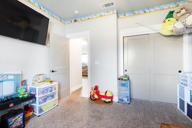 recreation room featuring visible vents and carpet