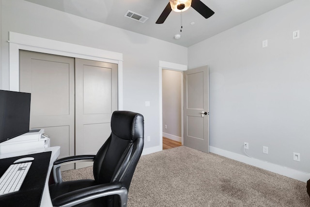 office featuring visible vents, baseboards, ceiling fan, and carpet flooring