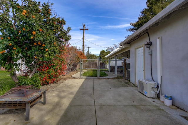 view of patio featuring ac unit, a gate, and fence