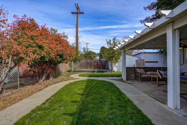 view of yard featuring an outdoor living space and fence private yard