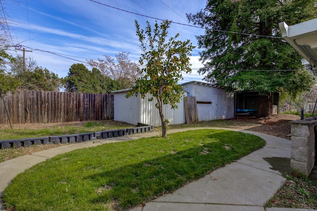 view of yard with an outdoor structure and fence