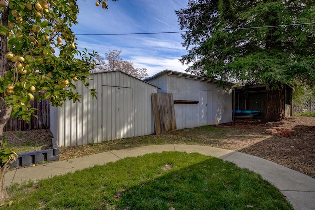 view of yard featuring an outbuilding, fence, and a shed