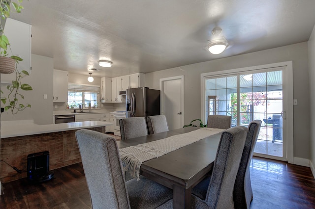 dining area featuring dark wood finished floors