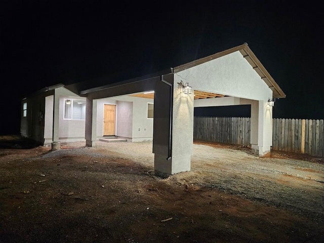 exterior space featuring a garage, driveway, and fence