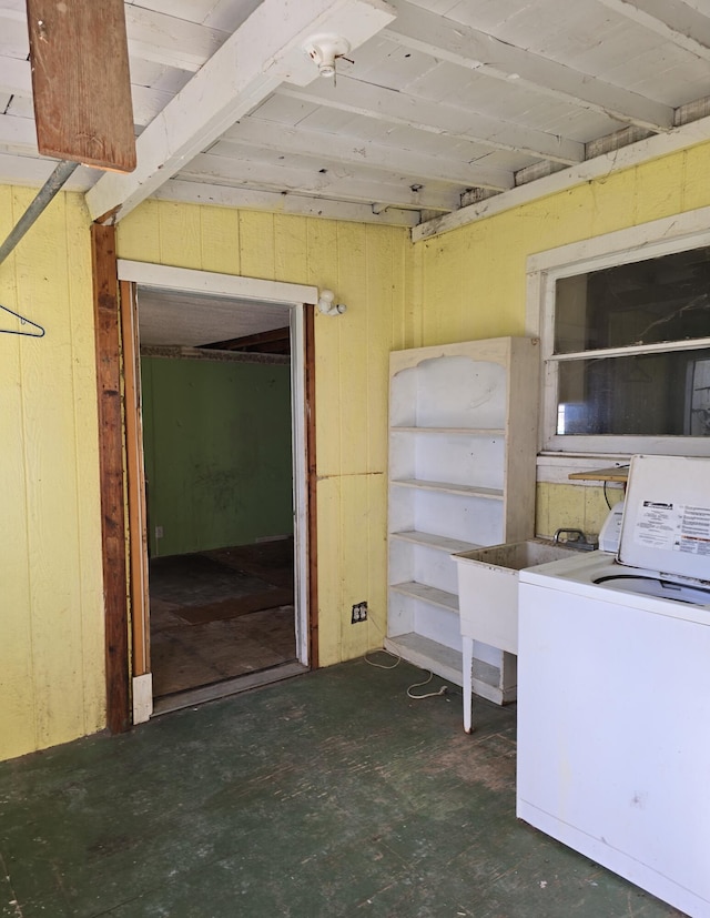 basement featuring wooden walls and washer / clothes dryer