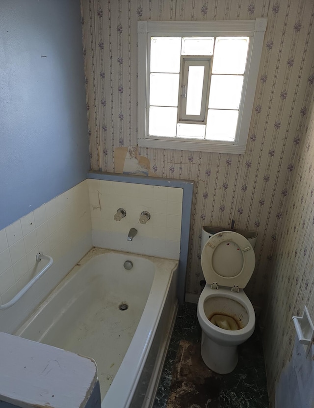 full bathroom with wallpapered walls, toilet, and a bath