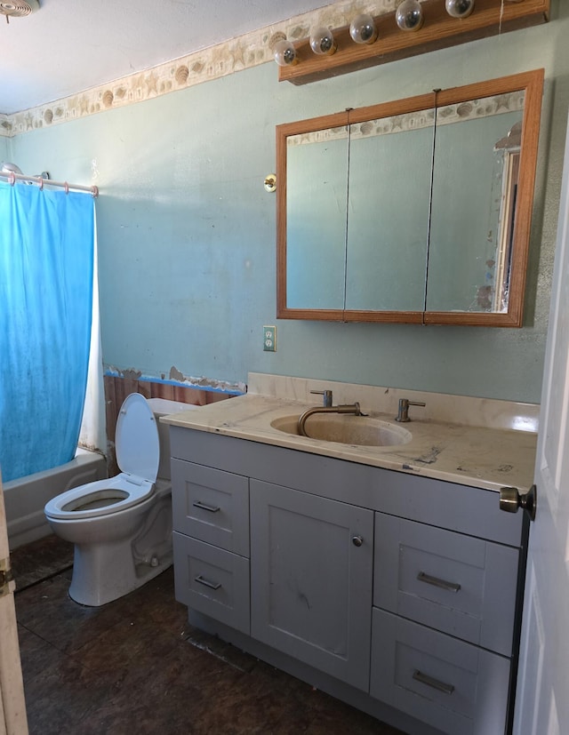 bathroom featuring vanity, toilet, and shower / bath combo with shower curtain